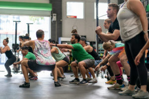 Group of athletes holding the bottom of a squat.