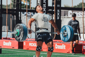 Invictus Athlete making aggressive barbell contact during a snatch at the CrossFit Games.
