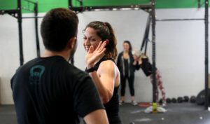 An athlete and coach High-fiving each other.