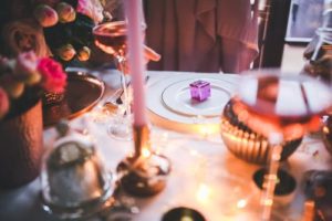 Beautifully set holiday table with candles and other decorations.