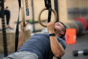 An athlete doing a ring row.